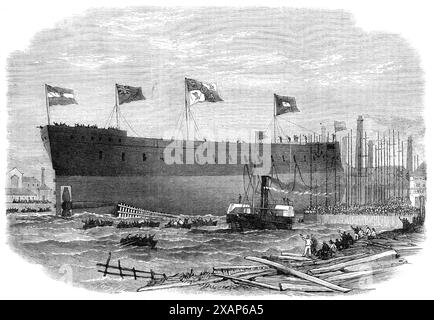 Start der eisernen Fregatte Victoria, gebaut für die Königin von Spanien in Blackwall, [London], 1865. Kriegsschiff gebaut von der Thames Iron Works Company. "... Ihre Bewaffnung ist dreißig Geschütze von großem Kaliber, und ihre Motoren, die von Penn und Co. Hergestellt wurden, von 1000 Pferden Nennkraft... zwei katholische clergymen...proceeded, um das Schiff in der Form zu segnen, die das römische Ritual vorschreibt, indem sie das folgende Gebet benutzen: "Sei günstig, o Herr! Auf unsere Bitte und mit deiner heiligen rechten Hand segne dieses Schiff und alle, die es trägt, so wie du es gestanden hast, die Lade Noahs zu segnen, die über der Sintflut schwebt. Stockfoto