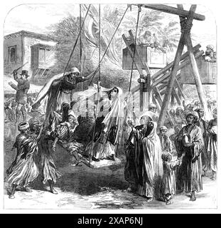 Szene beim Mohammedan Festival des Bairam, in Alexandria, [Ägypten], 1869. Allgemeine Freude...nach dem langen Fasten des Ramadan, ...in Arabisch, heißt es EED-e'-Sogheir...in der Nähe der Pompeius-Säule gab es tolle Unternehmungen...die Hauptattraktionen schienen Schaukeln und Karussells zu sein. Ich sah einen Mann auf Stelzen, und sein Kostüm, aus dem Mantel, dem Hut und dem Bart des Schleppkopfes, der auf einem falschen Gesicht feststeckte, muss dazu bestimmt gewesen sein, einen Engländer zu repräsentieren; er hat mit einem großen Stock herumgeschwemmt, wie der typische Ire auf der Donnybrook Fair. Die Schaukeln waren sehr einfache Konstruktionen - ein Stück o Stockfoto