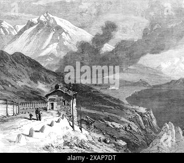 Die neue Überlandroute nach Indien: Die Eisenbahn über die Alpen – Gipfel des Mont Cenis und See, 1869. Ein '...Blick auf den Gipfel des Mont Cenis, mit dem Hospiz und dem See, die jedem vertraut sind, der eine italienische Tour gemacht hat. Der Hauptgipfel heißt Grand Mont Cenis. Auf der anderen Seite des Sees, im Westen, befindet sich ein weiterer Gipfel namens Little Mont Cenis. Das Gebäude im Vordergrund ist eines der Zufluchtshäuser, die sich entlang des Passes befinden, in denen Reisende bei Schneestürmen Schutz finden können. Der schwere Charakter dieser Stürme wird durch die Tatsache angezeigt, dass s Stockfoto