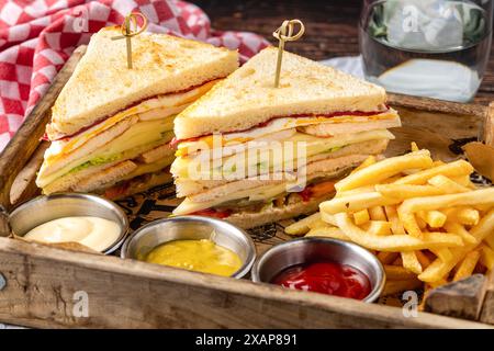 Chicken Club Sandwich mit Pommes, Ketchup, Senf und Mayonnaise Stockfoto