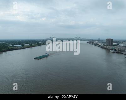 Aus der Vogelperspektive eines Binnenschiffs, der an der Skyline der Innenstadt von New Orleans auf dem Mississippi River vorbeifährt. Stockfoto