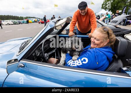 Mikael Karlsson und Anna Engberg, zusammen mit ihrem Hund Ella, in einem Volkswagen Karmann Ghia, während des Bug Run im Mantorp Park, Mantorp, Schweden, am Samstag. VW-Enthusiasten aus ganz Schweden treffen sich beim Bug Run, der dieses Jahr 40 Jahre feiert, hier treffen sich Menschen mit VW-Käfern, Bussen und anderen klassischen VW-Modellen. Stockfoto