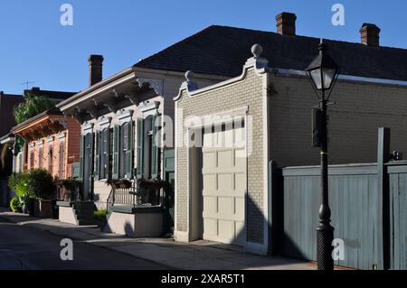 Bunt bemalte Landhaus-Reihenhäuser mit hoch dekorativen Fassaden und kunstvollen Holzarbeiten in einer Seitenstraße im New Orleans French Quarter Stockfoto