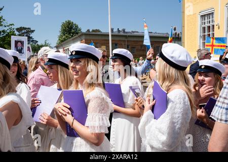 SCHÜLER, DIE DIE SCHULE ZUM LETZTEN MAL VERLASSEN, CELEBRATION, Åland, FINNLAND: Die neuen Absolventen kommen zum letzten Mal aus ihrer Schule, um einen ausgelassenen Empfang von Freunden und Familien zu feiern, die sich vor dem Hauptschulgebäude zum Åland-Abschlussfeiertag 2024 im Åland Lyceum (Ålands Gymnasium) in Mariehamn, Åland Archipel, versammelt haben. Ostsee, Finnland – an diesem Tag verlassen die Schüler die Schule zum letzten Mal. Im Rahmen dieser nordischen Tradition werden Plakate mit Babybildern der Absolventen aufgehalten und die Studenten tragen ihre Studentmössa im Matrosenstil. Stockfoto