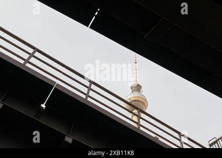 Blick auf den Fernsehturm durch zwei Eisenbahnbrücken am Berliner Bahnhof Alexanderplatz Stockfoto