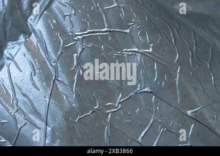 Zerknitterte Aluminiumfolie mit metallischem Hintergrund. Material Silber. Isolationspaneel, Schmirgelstruktur. Stockfoto