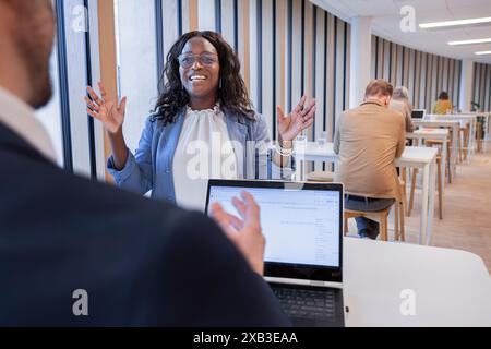 Geschäftsfrau diskutiert mit Kollegen am Tisch in der Bürokantine Stockfoto