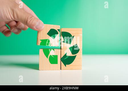 Mann Hand mit einem Holzblock Energiesparkonzept recycelte Abfallwirtschaft, umweltfreundlich, Rettet die Erde, Tag der Erde, Kampagne, um eine zu sammeln Stockfoto