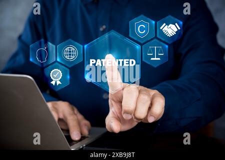 Patentiertes Patenturheberrecht Business Technology Konzept. Geschäftsmann, der Laptop mit patentiertem Wort mit Copyright-Icons für Urheberrechte und Pate verwendet Stockfoto