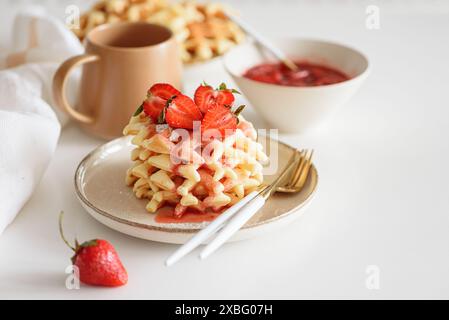 Belgische Waffeln mit Erdbeeren und frischer Marmelade auf weißem Tisch. Sommer-Food-Konzept. Weichzeichner Stockfoto