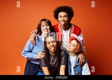 Eine vielfältige Gruppe junger Freunde, darunter ein nicht-binäres Individuum, die zusammen in stilvoller Kleidung in einer Studioumgebung stehen. Stockfoto