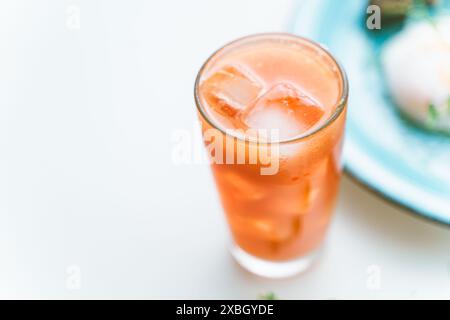 Grapefruit frisch gepresster Saft mit Eis in einem Glas auf weißem Hintergrund, ausgewählter Trick. Ein Ort, an dem ein Leerzeichen kopiert werden soll. Hochwertige Fotos Stockfoto