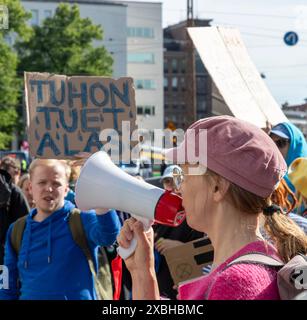 Chorleiter bei der „Sturmwarnung“-Proteste der Extinction Rebellion Finland am 11. Juni 2024 im Kreisverkehr Kaisaniemi in der Innenstadt von Helsinki. Stockfoto