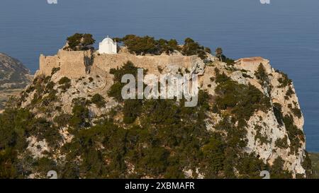 Kleine Kapelle und Burgruinen auf einem bewaldeten Felsen mit Blick auf das Meer, Kapelle St. Panteleimon, Kastro Monolithou, Burg Monolithos, Felsenburg Stockfoto