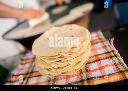 Ein Haufen frisch zubereiteter Tortillas ist auf einem Tuch in einem tortillería in Morelia, Michoacán, Mexiko, zu sehen. Stockfoto