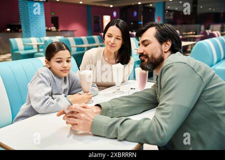 Eine fröhliche Familie genießt ein gemeinsames Essen in einem stilvollen Restaurant und schafft bleibende Erinnerungen an Zweisamkeit und Freude. Stockfoto