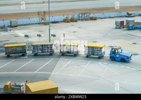 Gepäckwagen im Zug transportieren Passagierkoffer zum Verladen in das Flugzeug Stockfoto