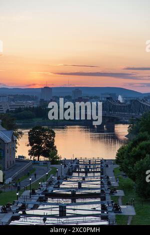 Ottawa, Kanada - 4. Juni 2024: Rideau-Kanalschleusen in Ottawa, Kanada. Blick auf Ottawa River, Alexandra Bridge und Gatineau Stadt Quebec bei Sonnenuntergang Stockfoto