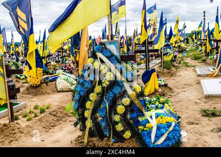 Charkiw, Ukraine, 13. Juni 2024 Aleja Slawy, Militärfriedhof südlich von Charkiw. Die Gräber von Soldaten, Helden, die die Ukraine verteidigten, sind bedeckt mit Stockfoto