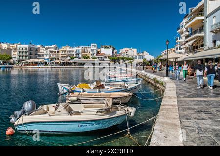 Boote, Passanten am Kai an der Lagune Voulismeni See in Agios Nikolaos, Ostkreta, Griechenland Stockfoto