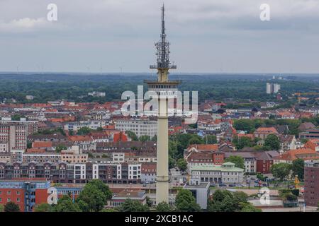 Ein hoher Fernsehturm erhebt sich über einem Stadtbild mit zahlreichen Gebäuden, der Himmel ist leicht bewölkt, Bremerhaven, Bremen, Deutschland Stockfoto