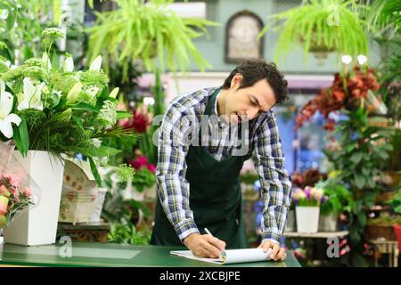 Blumengeschäft Blumenladen Auftragsannahme von einem Kunden am Telefon Stockfoto
