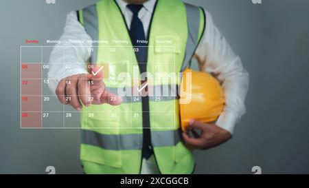 Architekt oder Ingenieur, der mit dem Finger auf Baudaten im virtuellen Kalender, Projektpräsentationsplan, Baukostenplanung, Konstrukt zeigt Stockfoto