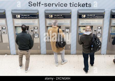 Aktenfoto vom 03/23 von Personen, die einen Fahrkartenautomaten am Bahnhof Waterloo in London benutzen. Die Daten des Office of Rail and Road zeigen, dass der Prozentsatz der Zugfahrten mit Saisonfahrkarten auf ein Rekordtief gefallen ist, da die Fahrkarten nur 13 % der 1,6 Milliarden Fahrten der britischen Eisenbahn im Jahr bis Ende März ausmachten. Ausgabedatum: Dienstag, 18. Juni 2024. Stockfoto