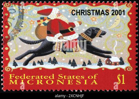 Illustration des Weihnachtsmanns, der auf einem Hund auf Briefmarken reitet Stockfoto