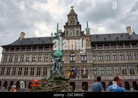 Antwerpen, Belgien; Juni, 07.2024; Brabo-Statue aus grüner Bronze auf dem Grote Markt. Details zum Handwerfen, während das Boot von Frauen gestützt wird, gegen Gra Stockfoto