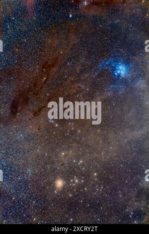 This is a portrait of the dust-filled region of sky in Taurus that frames the Hyades star cluster (at bottom) with bright yellow Aldebaran, up to the Stockfoto