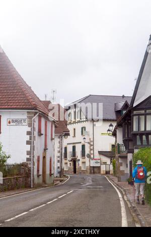 Pilger durch das spanische Dorf Burguete während eines Spaziergangs auf dem Jakobsweg Stockfoto