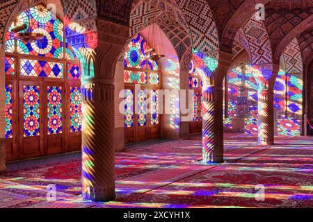 Shiraz, Iran - 31. Oktober 2018: Farbenfroher Blick auf das Morgensonnenlicht, das durch Buntglasfenster auf Säulen, Wand und Boden reflektiert wird. Stockfoto