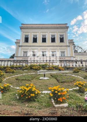 Blumenuhr mit der Katholischen Universität im Hintergrund. Petropolis, Rio de Janeiro, Brasilien. Mai 2024. Stockfoto