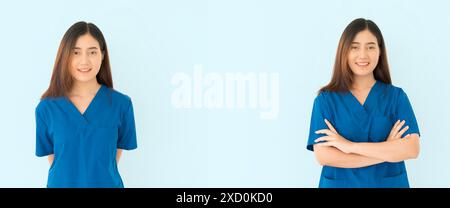 Zwei Frauen in blauen Schutten lächeln für die Kamera. Einer von ihnen trägt ein blaues Hemd mit Tasche Stockfoto