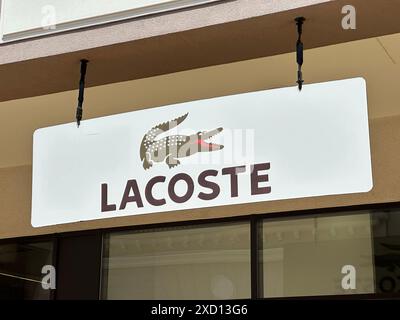 Belgrad, Serbien - 16. Juni 2024: Lacoste Storefront Logo und Schilder mit ikonischem Krokodil-Emblem, das Luxus und Mode symbolisiert Stockfoto