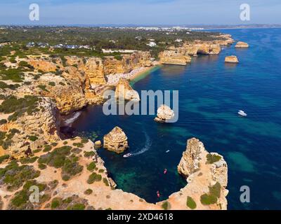 Luftaufnahme einer zerklüfteten Küstenlandschaft mit felsigen Inseln und Booten im türkisfarbenen Wasser, Strand, Praia da Marinha, Lagoa, Rocky Algarve, Algarve Stockfoto