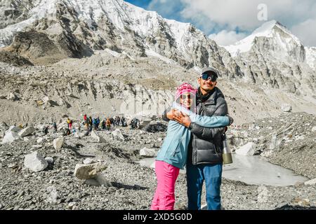 Junger männlicher Reiseleiter und Touristenfrau auf dem Everest Basislager, der sich die Kameraumarmungen ansieht. Himalaya-Trekking EBC. Männlicher nepalesischer Reiseleiter, der Touristen in die Stadt führt Stockfoto