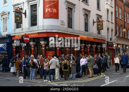 Leute trinken vor dem Coach & Horses Pub, Greek Street, Soho, London, Großbritannien. Juni 2024 Stockfoto