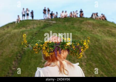 Krakau, Polen. Juni 2024. Die Teilnehmer feiern die Sommersonnenwende während der „Kupala-Nacht“ am Krakus-Hügel in Krakau, Polen am 20. Juni 2024. Die KupaÅ‚a Night ist ein altslawischer Feiertag, der auf die kürzeste Nacht des Jahres fällt. In dieser Nacht wurden Rituale wie das Sammeln und Herstellen von Kronen aus Kräutern und Wildblumen von Mädchen und jungen Frauen durchgeführt, Girlanden auf dem Wasser schickten, Feuer anzünden, tanzen, singen und über Feuer springen. (Kreditbild: © Beata Zawrzel/ZUMA Press Wire) NUR REDAKTIONELLE VERWENDUNG! Nicht für kommerzielle ZWECKE! Stockfoto