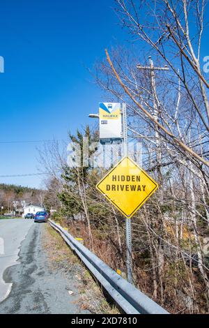 Bushaltestelle und versteckte Wegweiser auf der Purcells Cove Road in Fergusons Cove, Nova Scotia, Kanada Stockfoto