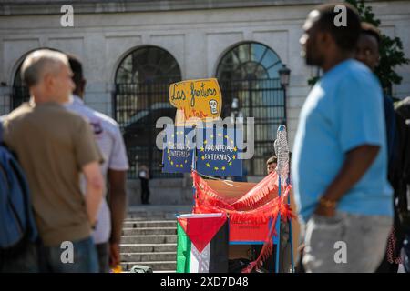 Madrid, Spanien. Juni 2024. Eine Gruppe von Personen nimmt an einer Leistung Teil. Organisationen und Gruppen der Zivilgesellschaft haben anlässlich des Internationalen Flüchtlingstages in der Umgebung des Reina-SofÌa-Museums zu einer Kundgebung aufgerufen. Quelle: SOPA Images Limited/Alamy Live News Stockfoto