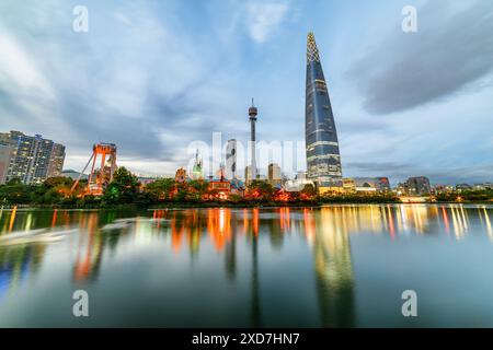 Seoul, Südkorea - 11. Oktober 2017: Fantastischer Abendblick auf den Lotte World Tower in der Innenstadt. Bunte Lichter der Stadt spiegeln sich im See. Stockfoto