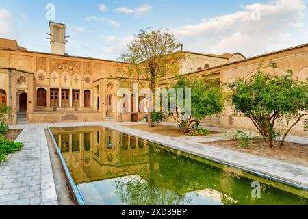 Wunderbarer Blick auf das historische Borujerdi Haus in Kashan, Iran. Traditioneller Innenhof mit Garten und Pool in der Mitte. Stockfoto