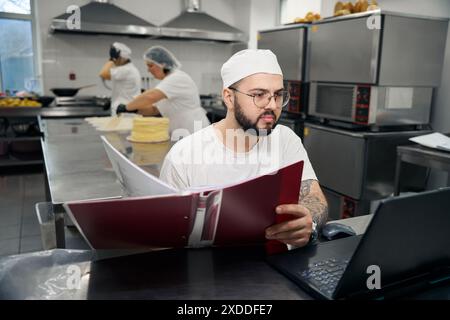 Der Mitarbeiter übernimmt die Buchhaltung für die Werkstatt für Halbfertigprodukte Stockfoto