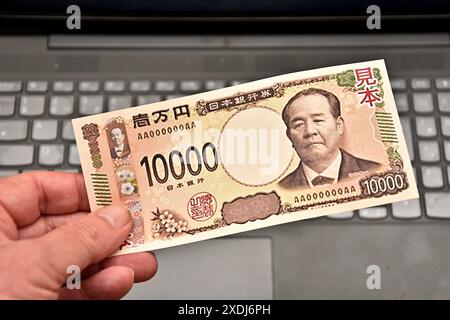 In dieser Abbildung hält ein Mann eine Probe einer japanischen 10.000-Yen-Banknote in der Hand. Um das Fälschungsrisiko zu verringern, werden das Finanzministerium und die Bank von Japan Anfang Juli 2024 neue Banknoten in Höhe von 1.000, 5.000 und 10.000 Yen in Umlauf bringen. Stockfoto