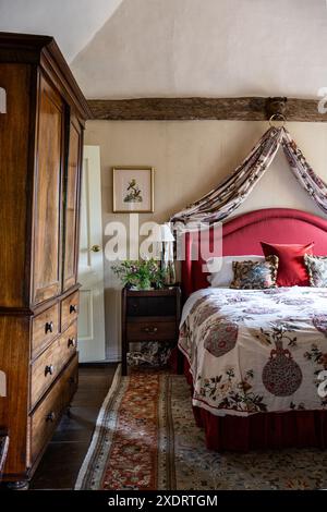 William IV. Schrank mit Tablett und Vintage-Stoffen und Kleiderschrank im Schlafzimmer des Tudor Farmhouse aus dem 16. Jahrhundert in Hertfordshire, England, Großbritannien. Stockfoto