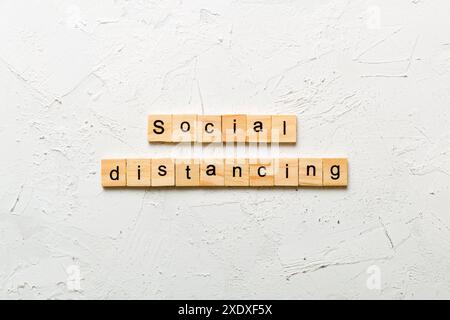Soziale Distanzierung Wort auf Holzblock geschrieben. Soziale Distanzierung Text auf Zementtisch für Ihr Design, Konzept. Stockfoto