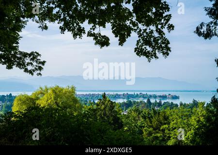 Deutschland, Lindau Altstadthäuser auf der Insel umgeben vom stillen bodenseewasser am frühen Morgen, alpen Berge in nebeliger Atmosphäre, Panoramablick Stockfoto