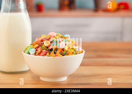 Eine Schüssel mit Rainbow-farbenen Marshmallow Kids Müsli mit fruchtigem Geschmack auf einem Holztisch in der Küche Stockfoto
